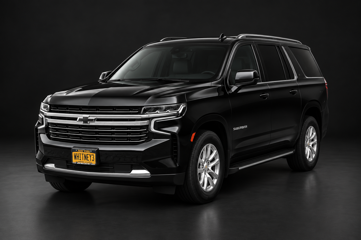 Whitney's black Chevrolet Suburban against a dark studio background